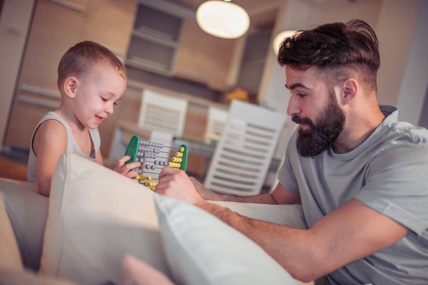 Young father spending time with toddler son at home - Photo, Image