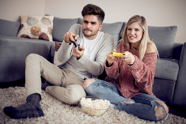 Young couple playing video games at home - Photo, Image