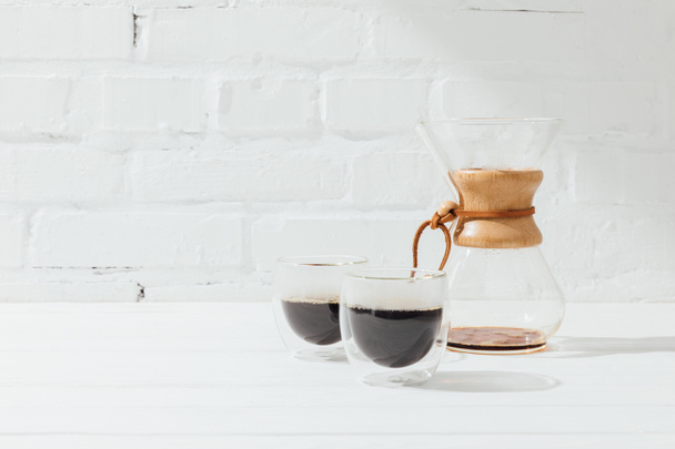Two glass mugs with alternative coffee and chemex  - Фото, зображення