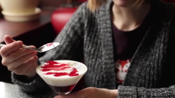 Woman eating panna cotta with a spoon - Footage, Video