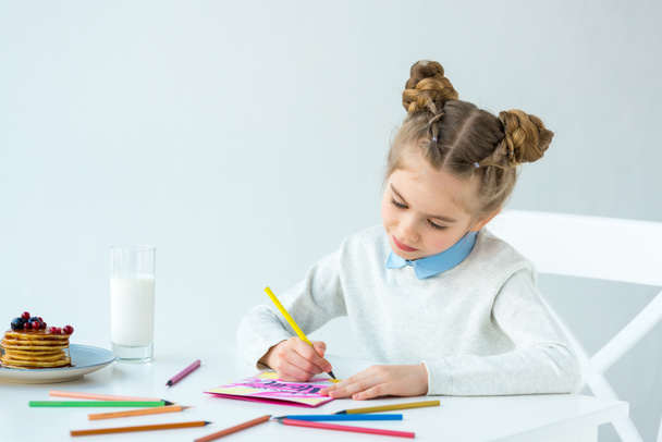 portrait of kid drawing greeting postcard for mother with colorful pencils at table, mothers day holiday concept  - Valokuva, kuva