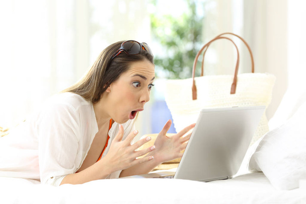 Excited woman reading online content on vacations - Foto, imagen