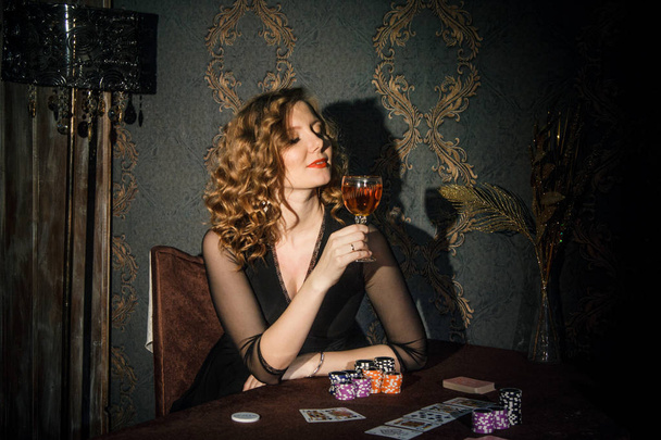 Woman in black dress plays in playing cards - Zdjęcie, obraz