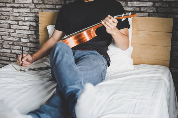 Young happiness man on bedroom in enjoying playing the music and - Φωτογραφία, εικόνα