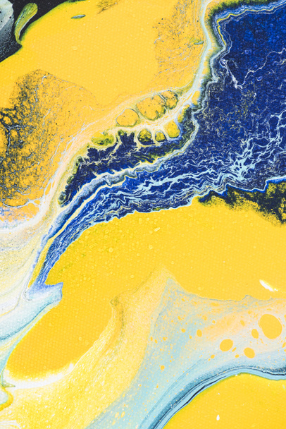 close up of abstract texture with yellow and blue acrylic paint - Zdjęcie, obraz