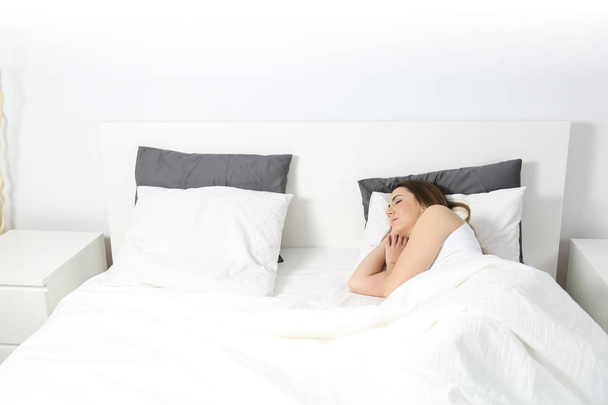 Wide view of a woman sleeping in a bed - Fotó, kép