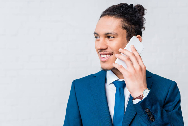 African american man in suit talking on the phone - 写真・画像