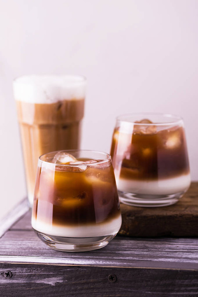 Iced coffee in glasses with milk. Black background - Zdjęcie, obraz