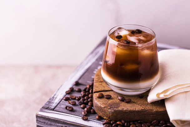 Iced coffee in glasses with milk. Black background - Фото, зображення
