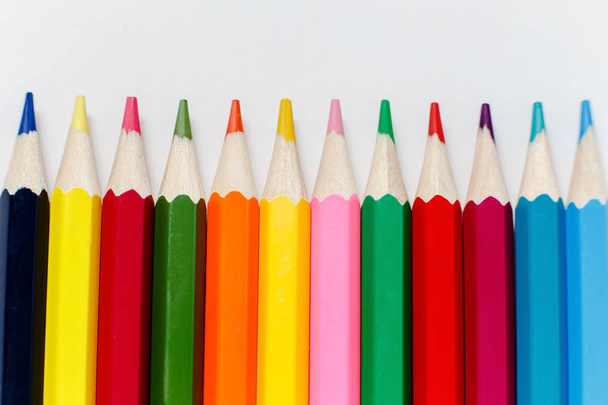 a set of colored pencils lined in a row - 写真・画像