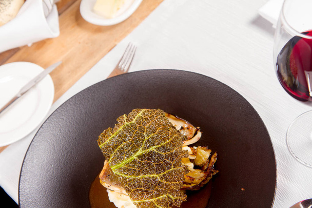 Sturgeon, savoy cabbage, mushrooms broth, mashed potato with butter served in a restaurant - Φωτογραφία, εικόνα