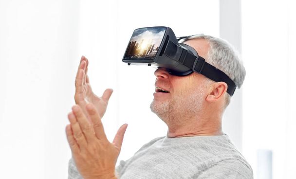 old man in virtual reality headset or 3d glasses - Фото, изображение