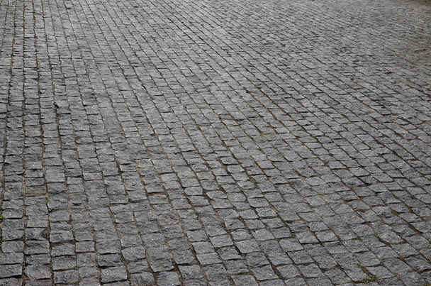 A textura da laje de pavimentação (pedras de pavimentação) de muitas pequenas pedras de forma quadrada sob luz solar brilhante
 - Foto, Imagem