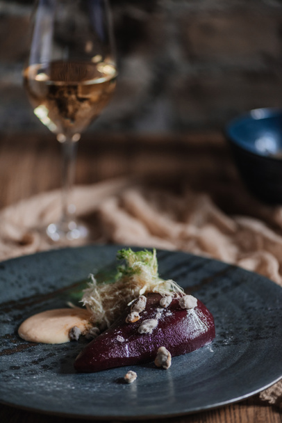 close-up view of delicious pear in wine with cream sauce and caramelized pistachios - Photo, Image
