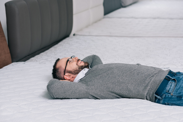customer lying on orthopedic mattress - Фото, изображение