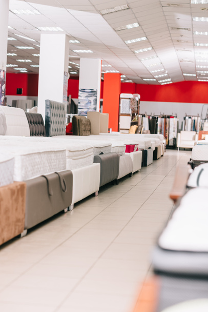 interior of furniture store with arranged mattresses around - Photo, Image