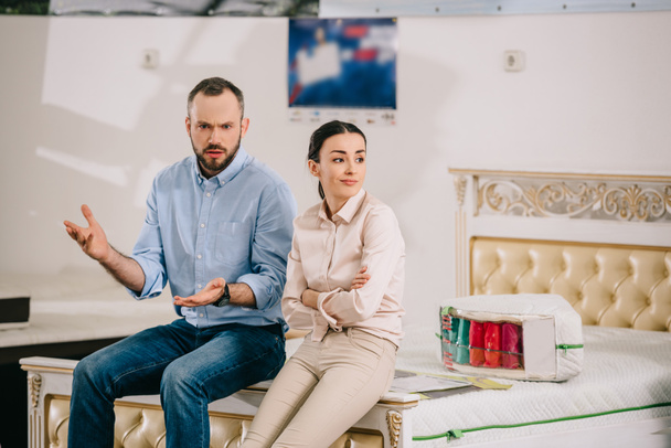 portrait of couple having disagreement in furniture store - Photo, Image