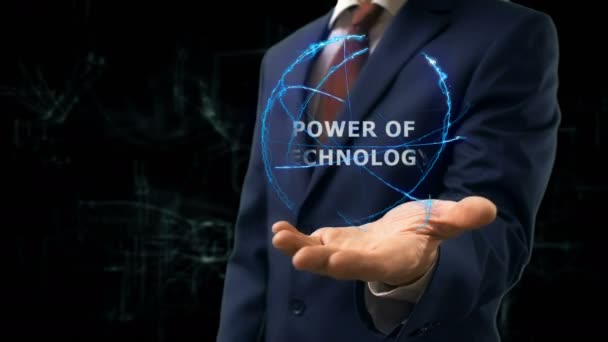 Businessman shows concept hologram Power of technology on his hand - Footage, Video