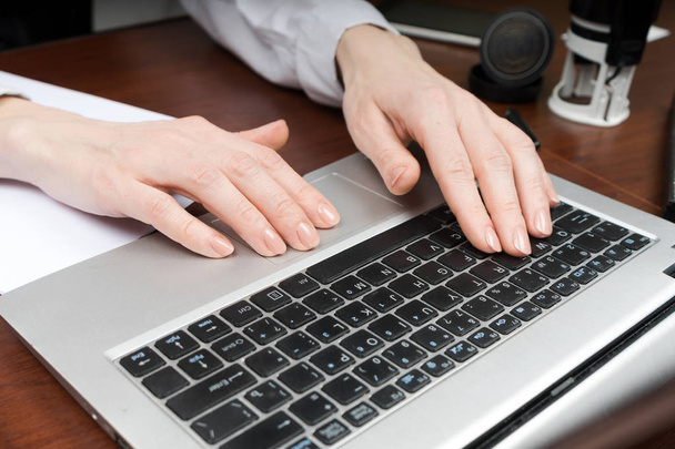 Closeup of a female hands busy typing on laptop. Copy space. - Foto, imagen