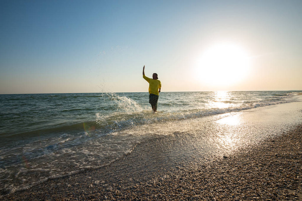 Joyful adventurer splashing water and having fun - Fotografie, Obrázek