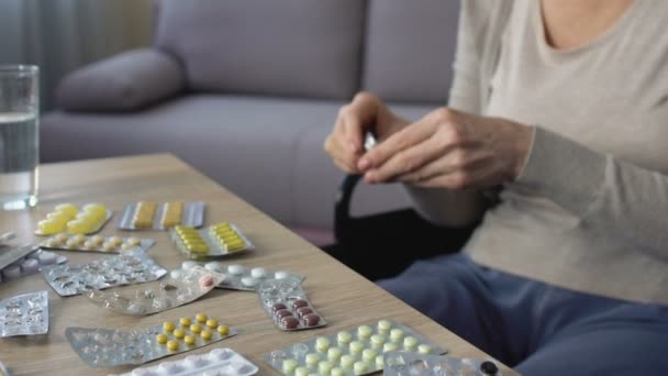 Sick woman taking painkiller pills at home, overusing medicine, cancer treatment - Кадри, відео