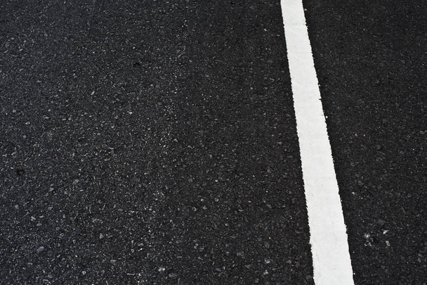 Fechar a superfície asfáltica da estrada dividir linhas brancas
 - Foto, Imagem