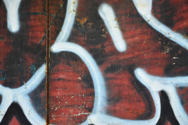 Texture of a fragment of the wall with graffiti painting, which is depicted on it. An image of a piece of graffiti drawing as a photo on street art and graffiti culture topics - Photo, Image