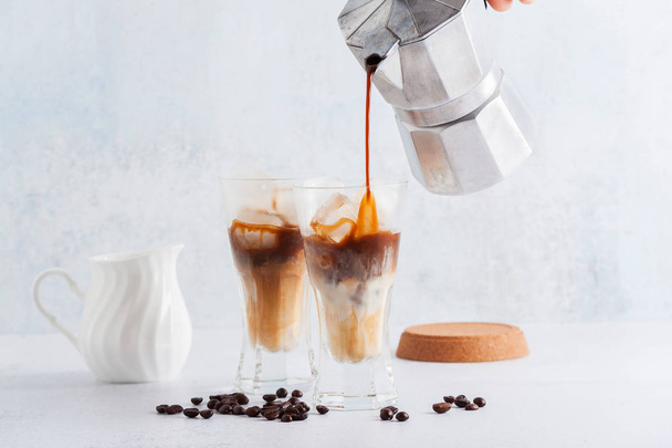 cold brew coffee on tPour milk in cold brew coffee on the table. - Foto, immagini