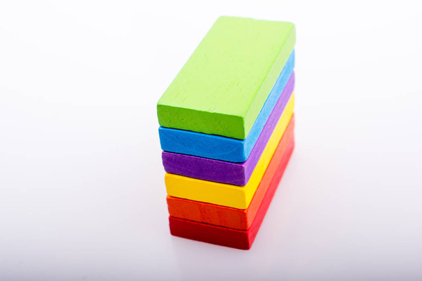 Colorful Domino Blocks in a line on a white background - Foto, Imagen