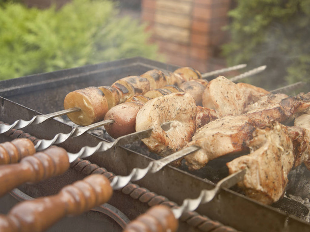 Barbecue meat and potatoes on the grill, skewers - Photo, Image