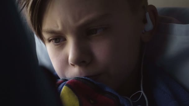 Kid using tablet on window sill - Footage, Video
