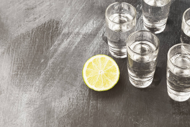 Cold vodka in shot glasses on a black background. Copy space. Fo - Foto, Imagem
