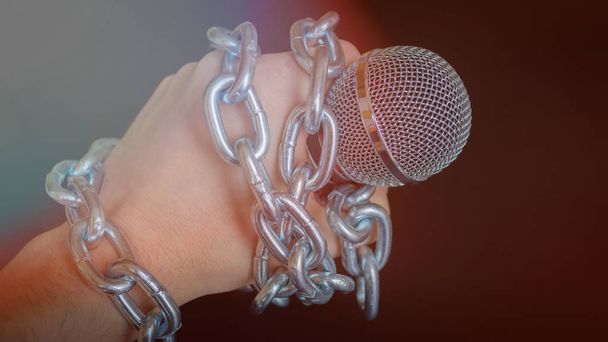 Microphone and chain. Freedom of the press is at risk concept - World press freedom day concept - Photo, Image