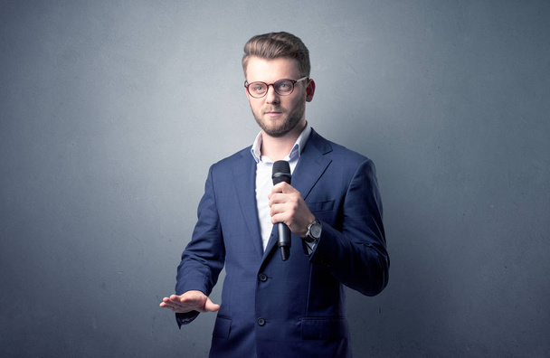 Businessman holding microphone - Φωτογραφία, εικόνα