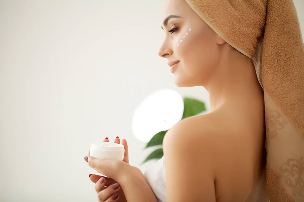Skin care. Studio shot of beautiful young woman applying moistur - Photo, Image