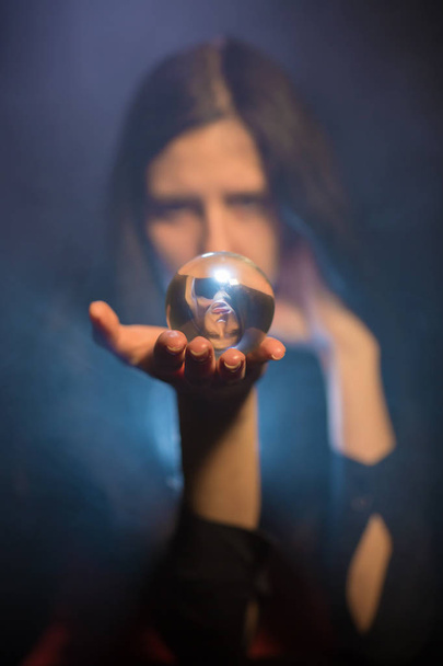 The woman holds a magic sphere - Foto, Imagen