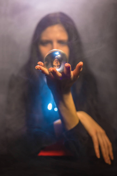 The woman holds a magic sphere - 写真・画像