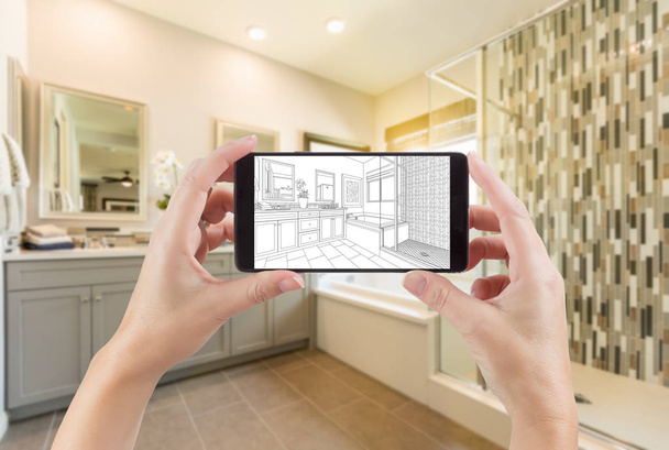 Hands Holding Smart Phone with Master Bathroom Drawing on Screen and Photo Behind. - Foto, Imagem