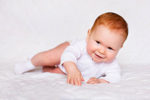 Portrait of adorableness. Little cute baby girl in white romper in bedroom - Fotoğraf, Görsel