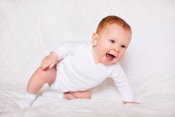 Portrait of adorableness. Little cute baby girl in white romper in bedroom - Fotografie, Obrázek