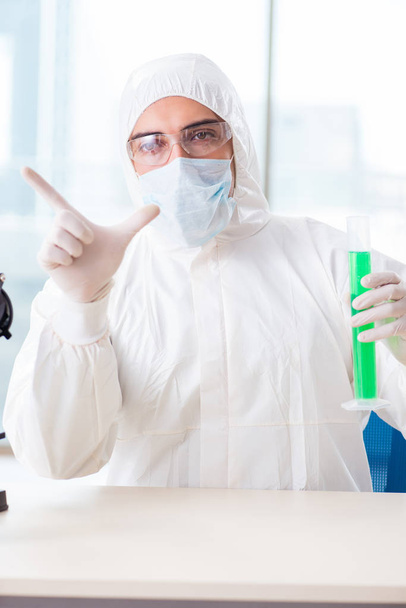 Jeune chimiste appuyant sur des boutons virtuels en laboratoire - Photo, image