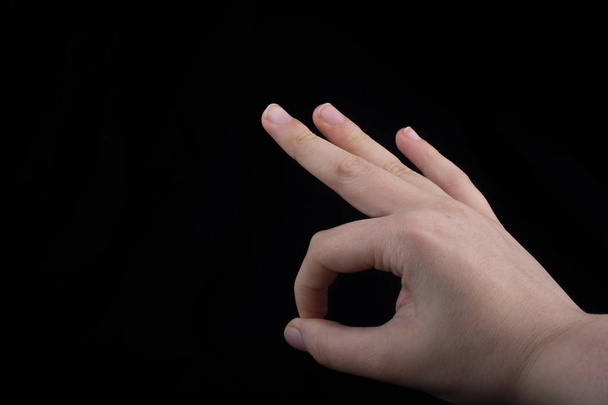 Hand gesturing sign ok, okay, agree on black background - Photo, Image