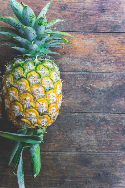 pineapple fruit on wood table - Fotó, kép