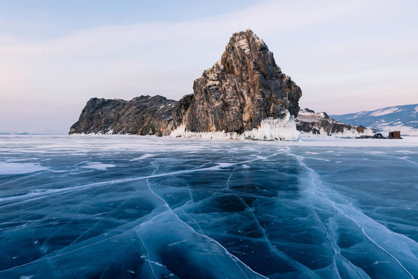 Cracking frozen water lake with rock mountain, Baikal Russia winter season natural landscape  - Photo, Image