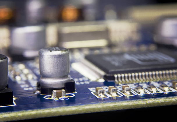 Close up macro of aluminum electrolytic capacitors installed on the motherboard. - Photo, Image