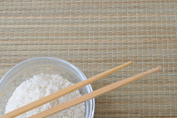 Vista superior del tazón de arroz blanco y palillos
 - Foto, Imagen