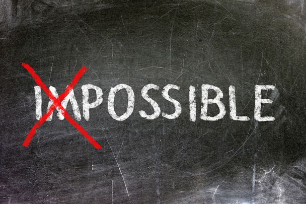 Impossible and possible option handwritten with white chalk on a blackboard. - Photo, Image