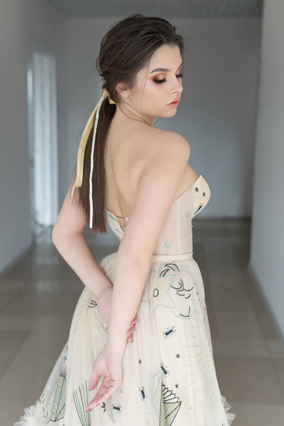 mooie sexy brunette meisje in elegante jurk met lange trein met lavendel - Foto, afbeelding