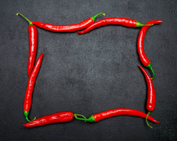 red chili pepper on dark concrete background - Фото, изображение