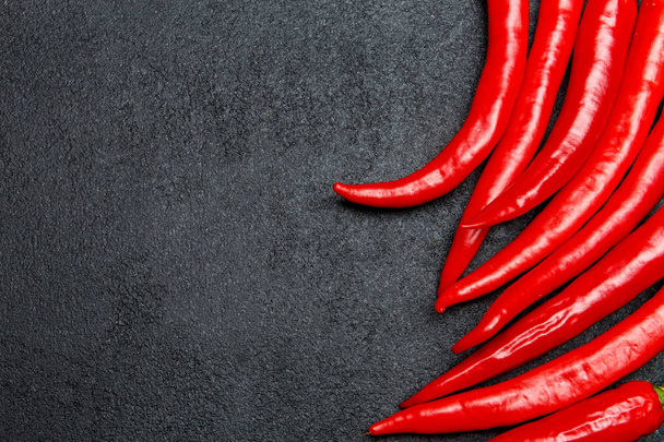 red chili pepper on dark concrete background - Фото, зображення
